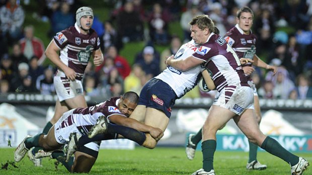 Dominating ... Manly get physical in defence in last night's convincing 24-4 victory against the North Queensland Cowboys.