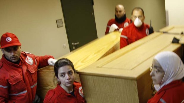Last journey &#8230; Syrian Red Crescent members with the caskets containing the bodies of the journalists killed in Homs.