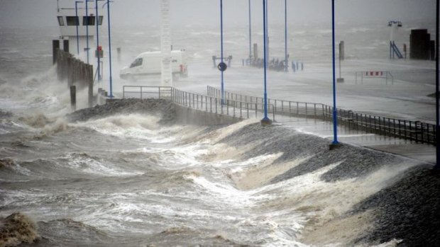Waves batter the North Sea coast at the ferry dock in Dagebuell, northern Germany.
