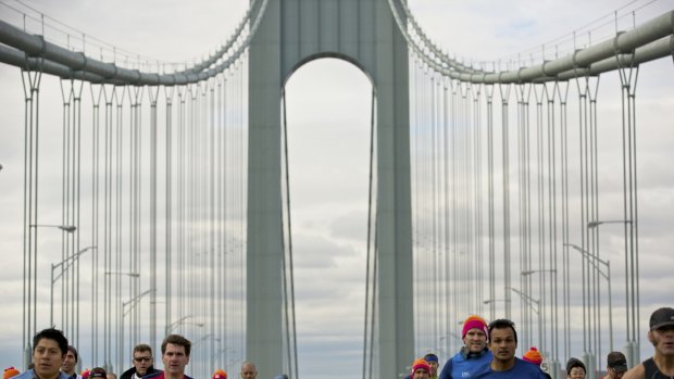 FILE -- Exuberant colors stand out as runners cross the Verrazano-Narrows Bridge during the New York City Marathon in the Staten Island borough of New York, Nov. 3, 2013. Some runners find the trend obnoxious, but bright shoes and gear are becoming ubiquitous on running circuits around the world. (Benjamin Norman/The New York Times)