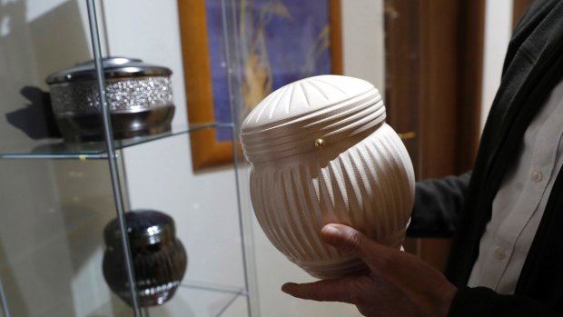 Urn models on display at a funeral parlor in Rome.