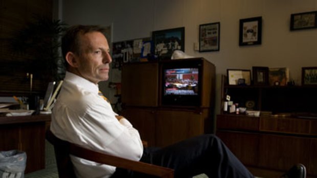 Mr Abbott watching in his office as the emission trading scheme bill was vote down in the Senate yesterday.