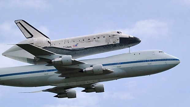 The space shuttle Discovery travels on the back of a Boeing 747 jumbo jet to its final destination - a museum outside Washington.