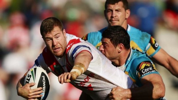 Going nowhere: Dragon Trent Merrin is tackled at WIN Jubilee Oval.