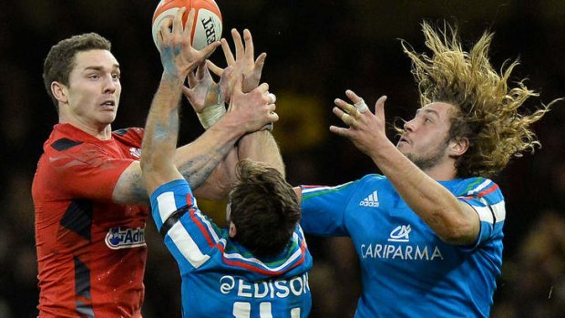 Wales wing George North (L) vies for the ball with Italy's Angelo Espostio (C) and Joshua Furno.