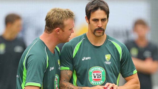 Imparting wisdom: Doug Bollinger gives Mitch Johnson a few pointers at training on Monday.