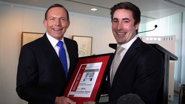 Prime Minister Tony Abbott presents Fairfax journalist Jonathan Swan with the 2014 Wallace Brown Young Achiever Award for press gallery journalism at Parliament House.