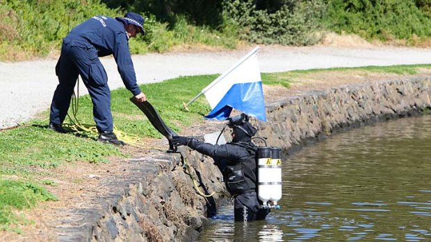 Police divers search Mordialloc Creek for the bin.