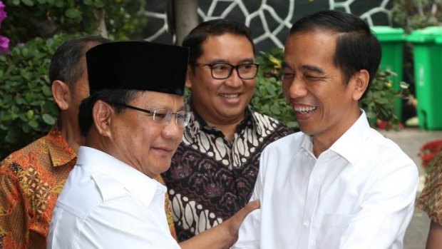 All smiles: President-elect Joko Widodo, right, shakes hands with defeated opponent and opposition leader Prabowo Subianto in Jakarta on Friday.