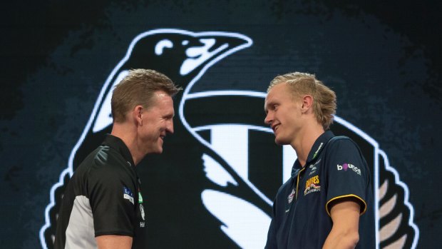 Jaidyn Stephenson of the Eastern Ranges (right) is presented with his guernsey by Magpies coach Nathan Buckley after being selected as the No.6 draft pick.
