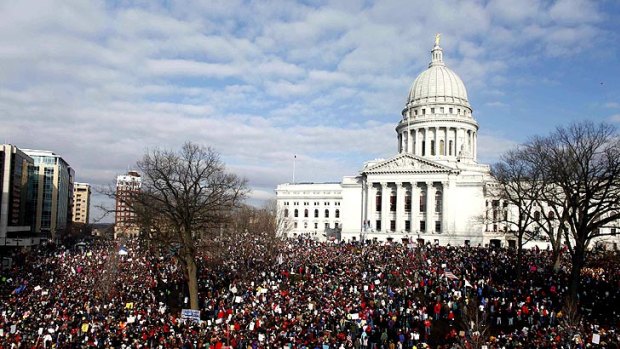 Demonstrators at Wisconsin’s State Capitol in Madison join 14 senators who left the state to protest a labour bill that curbs collective bargaining for public workers.