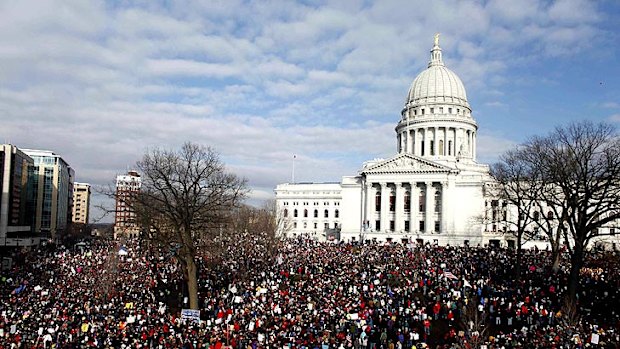 Demonstrators at Wisconsin’s State Capitol in Madison join 14 senators who left the state to protest a labour bill that curbs collective bargaining for public workers.