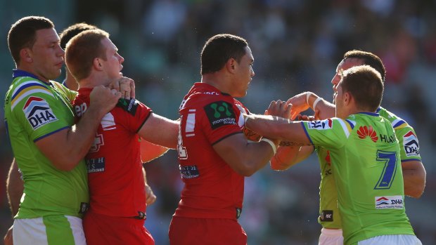 Scuffle: Dragons forwards Ben Creagh and Tyson Frizell have a disagreement with the Raiders in Wollongong.