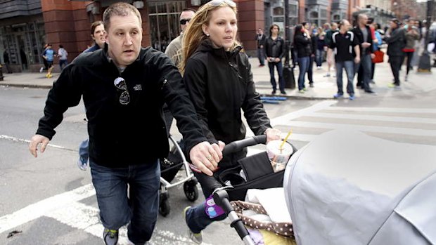 Spectators flee the scene near the finish line.