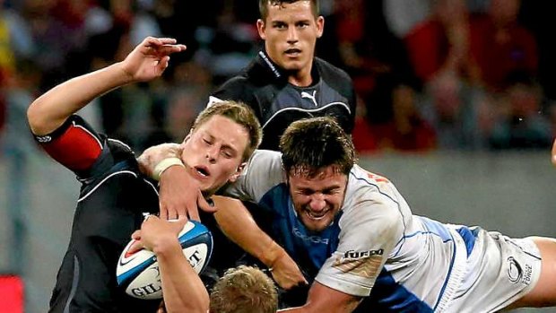 Welcome to Super Rugby ... Star recruit Hugh McMeniman of the Force tackles SP Marais.