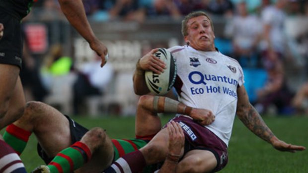 City's choice... Trent Hodkinson is pulled to ground yesterday.