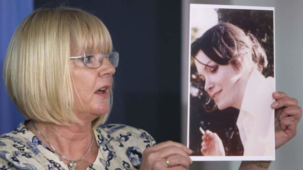Pauline Biddle holds a picture of her friend Mary Louise Wallace, who disappeared in September 1983.