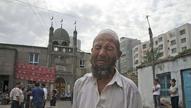 Distraught... a Uighur man reacts to questions about the attacks in Urumqi.