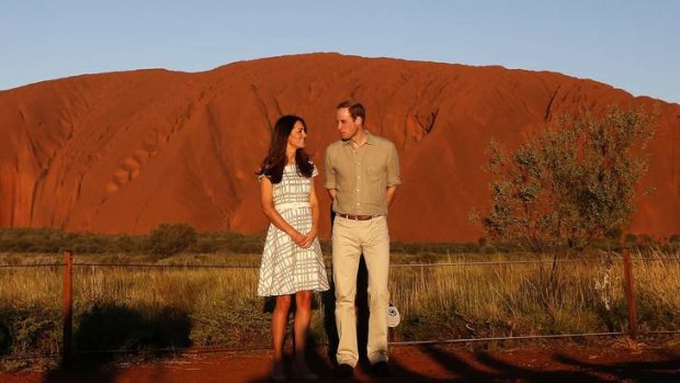 Britain's Prince William and his wife Catherine, Duchess of Cambridge, pose in front of Uluru.