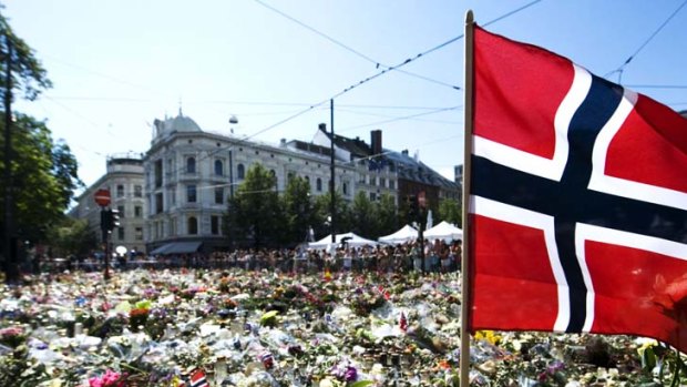 Reflection ... Norway's young and old have expressed their collective grief with flowers that carpet Oslo's cathedral square.