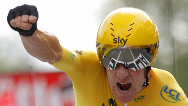 Punching ahead ... Britain's Bradley Wiggins hits the line to win Saturday's time trial, the penultimate stage of the Tour de France.