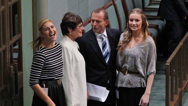 The Opposition Leader, Tony Abbott, embraces his wife, Margie, and daughters Frances (left) and Bridget after delivering his budget reply address last night.