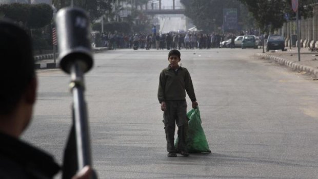 Continued unrest ... A boy looks at Egypt's security forces as they try to disperse supporters of ousted President Mohammed Mursi in Cairo.