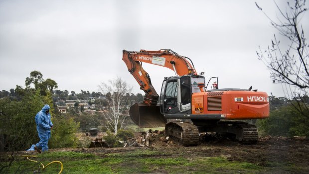 Say goodbye: Workers demolish a Mr Fluffy home in Woden on Tuesday morning.