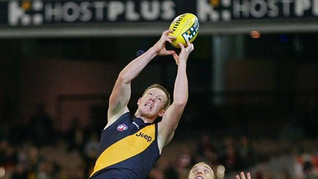 Got it: Richmond's Jack Riewoldt marks over Swan Ted Richards. He finished with four goals.