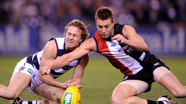 St Kilda's Sam Fisher (right) competes with Geelong's Mitch Duncan.