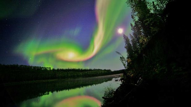 Swirls of green and red appear in an aurora over Whitehorse, Yukon on the night of September 3, 2012, as a result of the eruoption from the Sun.