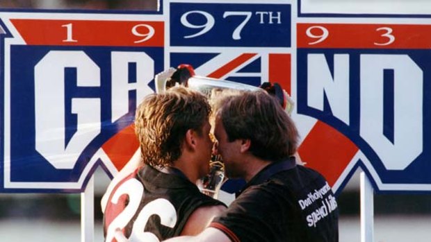 Essendon coach Kevin Sheedy and captain Mark Thompson embrace as they hold the 1993 premiership cup.