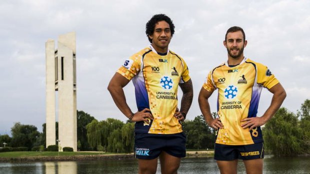Brumbies' Joe Tomane and Nic White show off the Centenary jumpers by the lake on Tuesday.