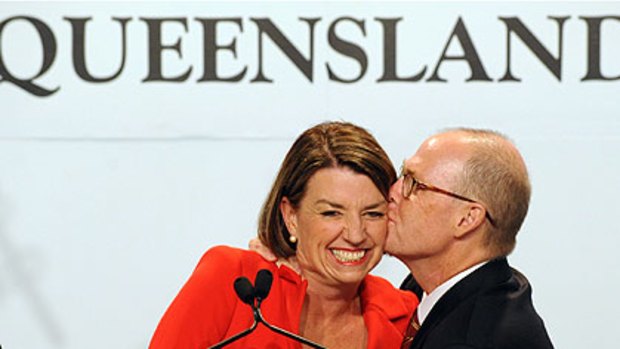 Winner's kiss . . . Ms Bligh with husband Greg Withers and (right) Lawrence Springborg with wife Linda last night.
