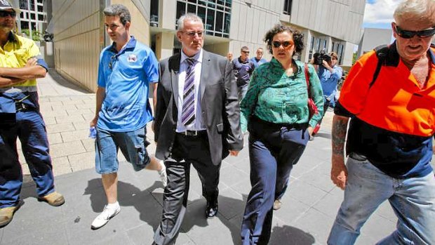 Unionist Bob Carnegie leaves the Brisbane Federal Court with his wife and supporters.