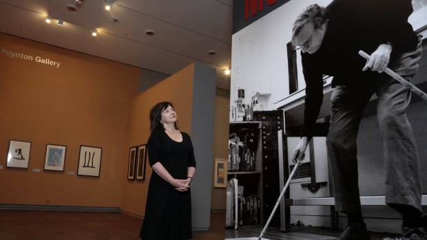 NGA senior curator Jane Kinsman studies a portrait of the artist at the Robert Motherwell exhibition.