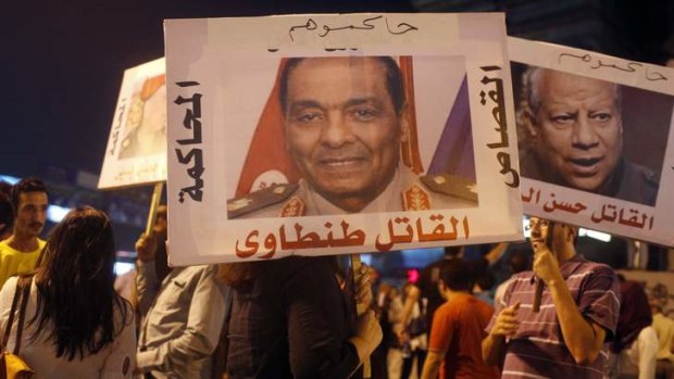 Activists from Third Square, a group  which promotes a middle way in the rift between the Muslim Brotherhood and supporters of the army's overthrow of Egyptian President Mohamed Mursi,  gather to oppose both parties at Sphinx Square in Cairo.