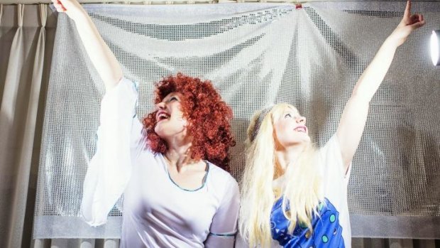 Meghan Black and Elizabeth Smith (red hair) pose in their ABBA costumes on April 30, 2015 in Sydney.