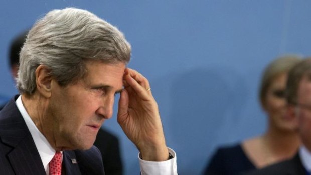 John Kerry listens to the opening address during a NATO meeting in Brussels on December 3. 