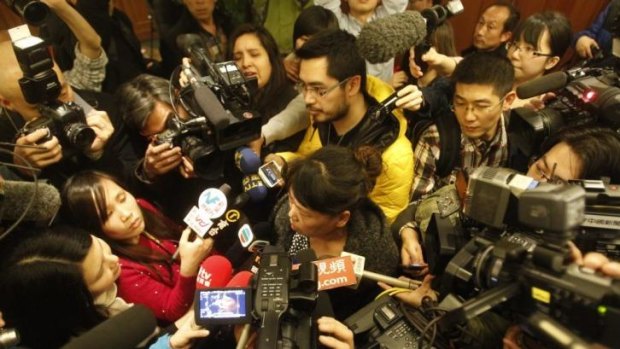 A relative of a passenger on board Malaysia Airlines flight MH370 answers media questions at Lido Hotel in Beijing, China.