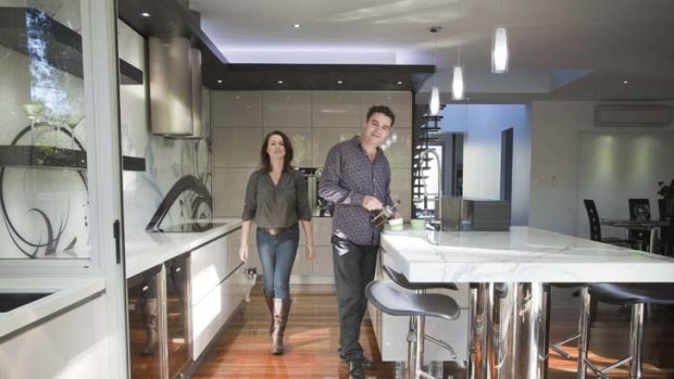 Room to move ... Kim Duffin, with his wife, Rebecca, won this year's kitchen designer of the year award for his 18-metre-long kitchen in his Brisbane home.