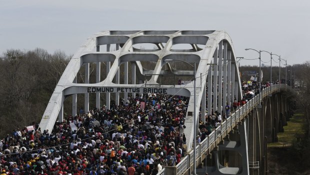 Crowds walk across the Edmund Pettus Bridge in Selma.