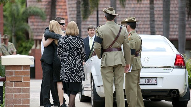 Captain Bryce Duffy's fiancee Candice is consoled before his funeral at Anglican Church Grammar School.
