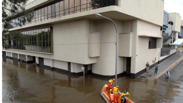 Queanbeyan ... an SES crew assesses water lapping the leagues club.