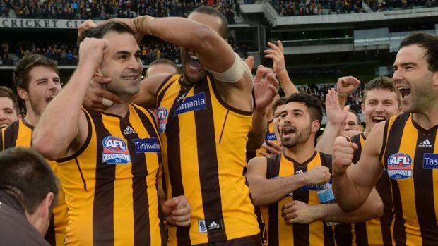 Brian Lake is congratulated by his teammates after being announced as the winner of the Norm Smith medal.