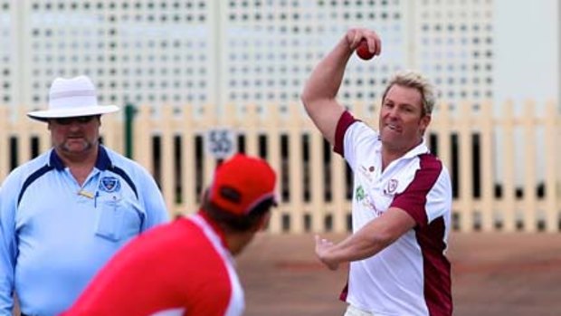 Shane Warne bowls to former NSW premier Morris Iemma in Sydney yesterday.
