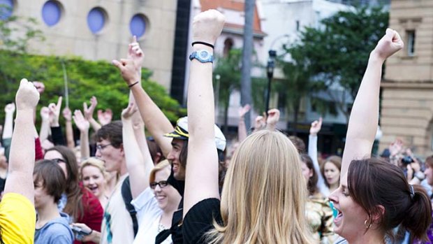 The crowd raises fists in support of the SlutWalk staged in Brisbane's streets.