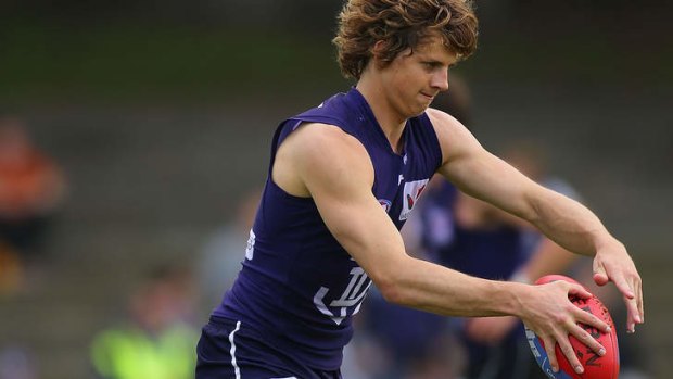 Nathan Fyfe passes the ball during the Dockers training session at Fremantle Oval.