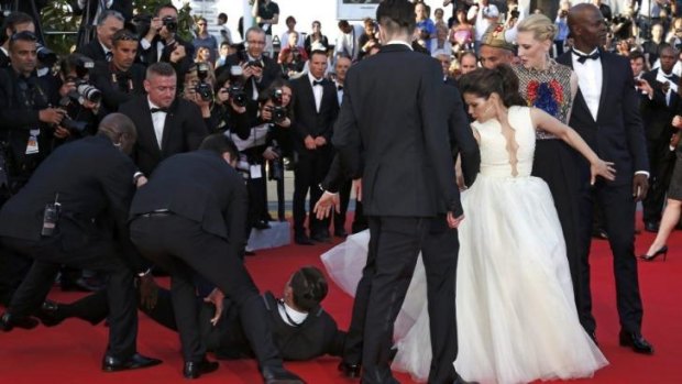 Cate Blanchett looks on as the man is dragged away.