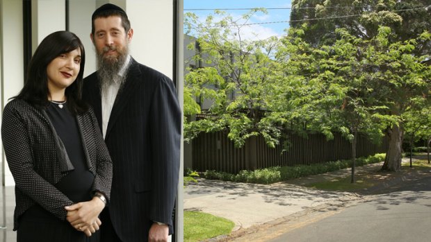 Nicole and Eliezer Kornhauser (left) at home and (right) the Springfield Avenue building at the heart of the conflict.